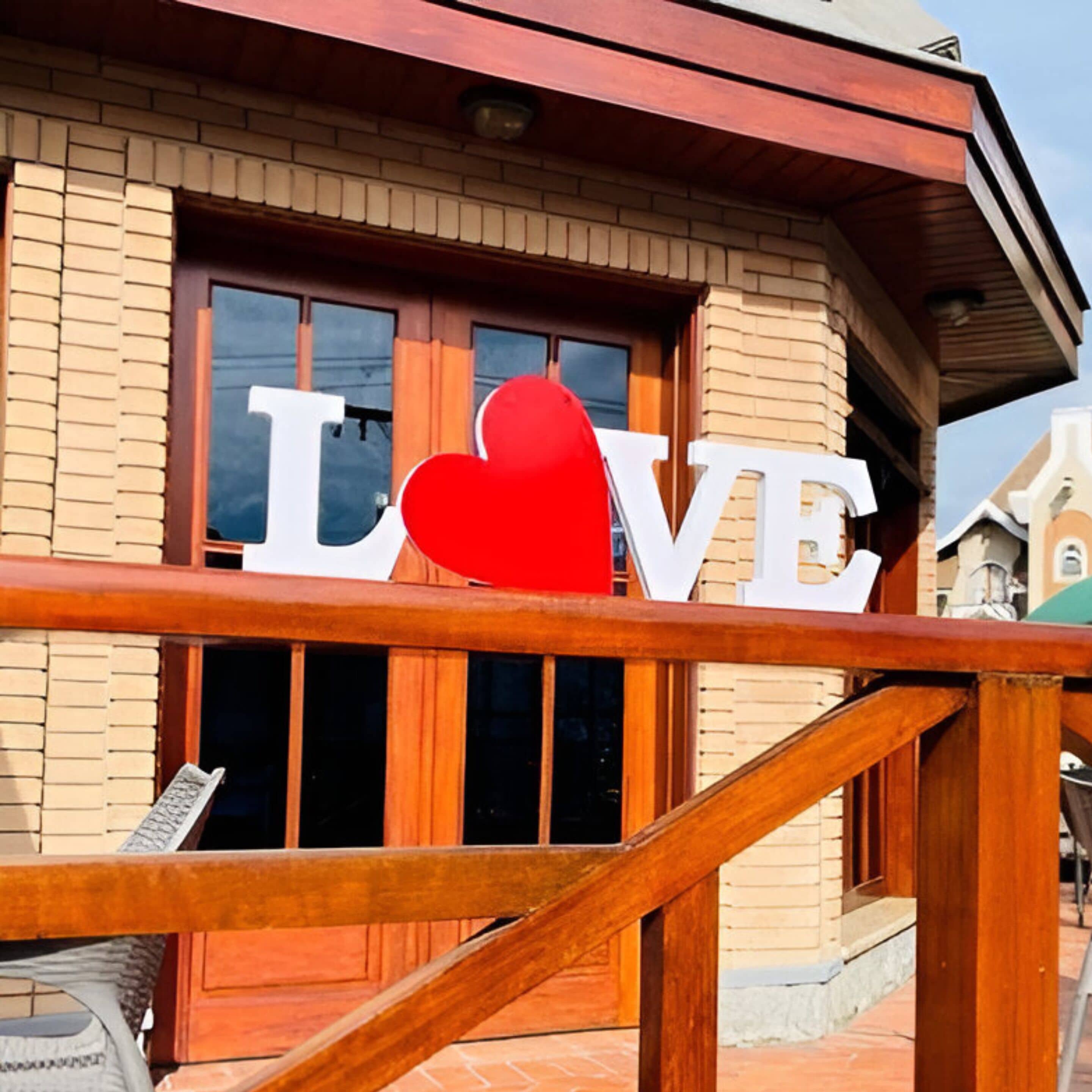 A building with a large 'LOVE' sign in front.