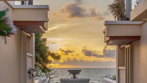 A corridor leading to a door with a view of the sea at sunset. - Mövenpick Phuket Bangtao (Choeng Thale)