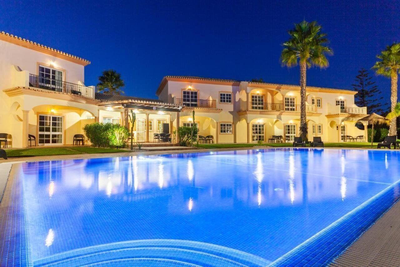 Una piscina al aire libre, sillones reclinables de piscina