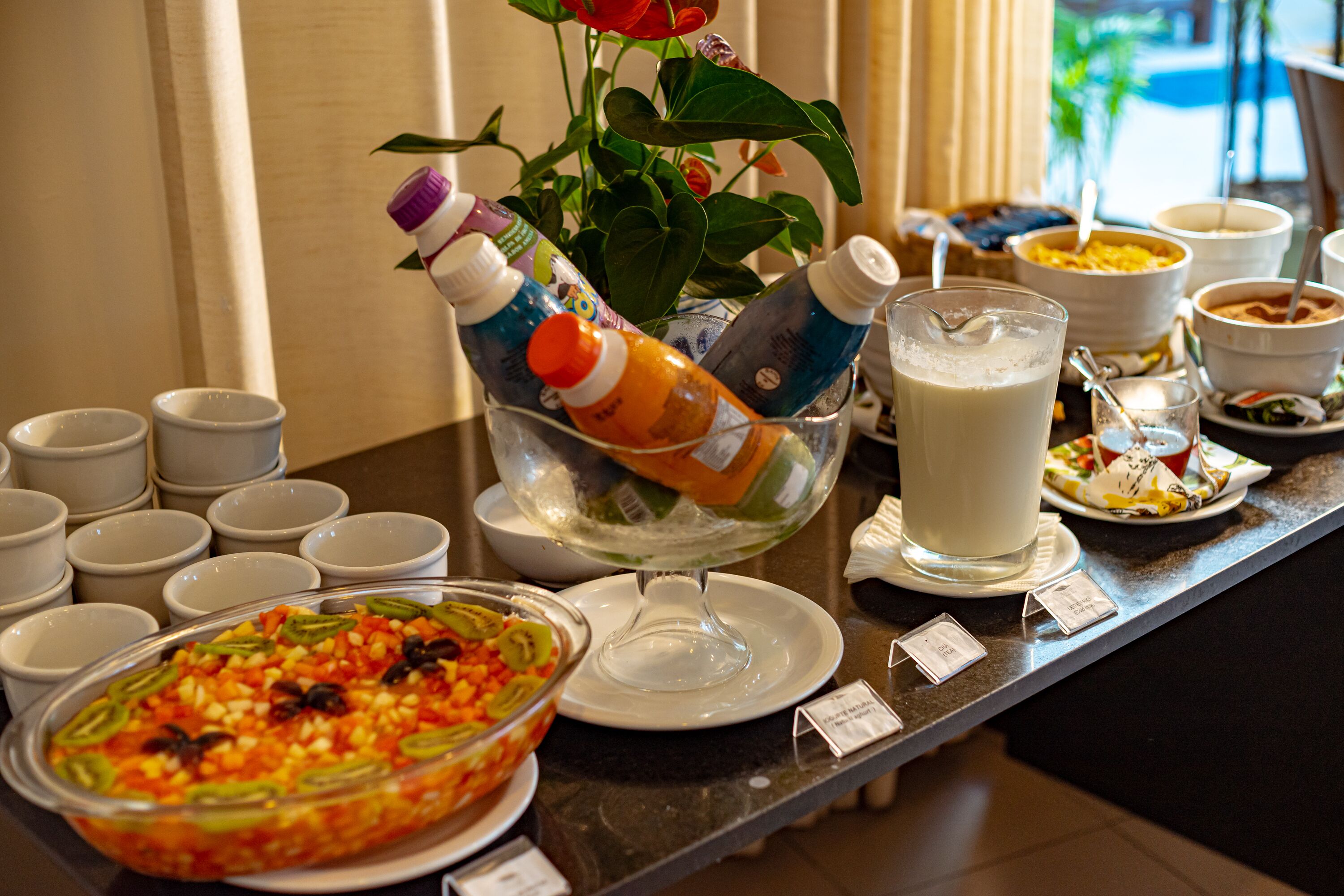 A buffet setup with various food items and beverages.