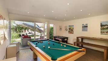 Relax by the pool, play a game of pool, or enjoy the view from the large window.