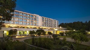 A multi-story hotel with a modern design, featuring balconies and a well-lit entrance. - Magal Maradiso Hotel by Aminess  (Omisalj)