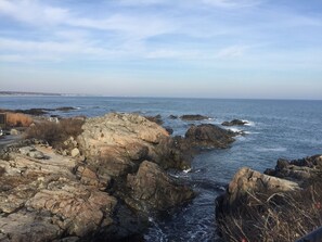 A rocky coastline with waves crashing against the rocks.