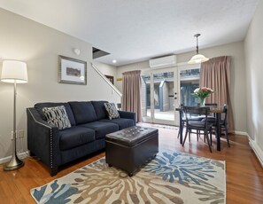 Townhouse Suite, 2 Queen Beds and Sofa Bed (Stairs Required) | Living area | Flat-screen TV