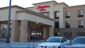 A Hampton Inn hotel with a clear entrance and a sign above the doors.