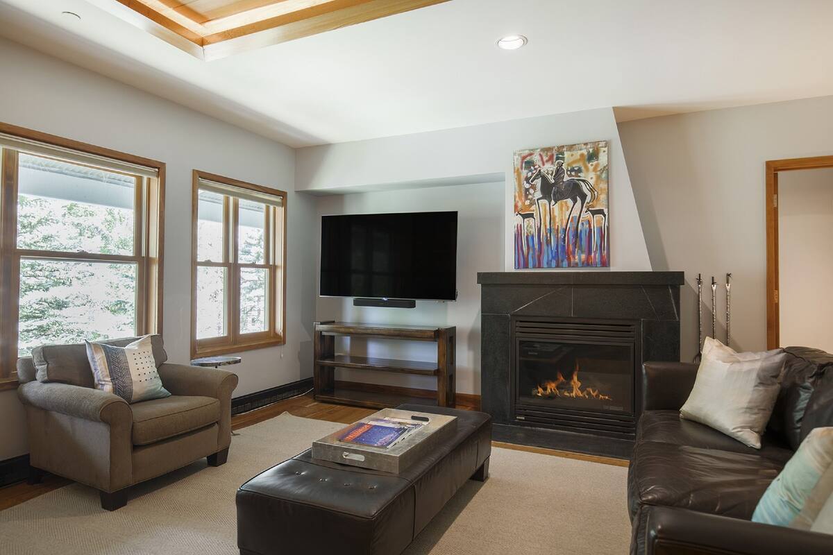 A living room with a fireplace, a television, and a sofa.