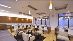 A modern hotel lobby with multiple seating areas, large windows, and contemporary lighting fixtures. - JR Inn Sapporo (Sapporo)