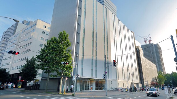 A modern building with a prominent vertical design, large windows, and a visible entrance area. - JR Inn Sapporo (Sapporo)