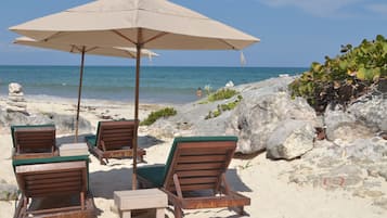 On the beach, sun-loungers, beach umbrellas, beach towels