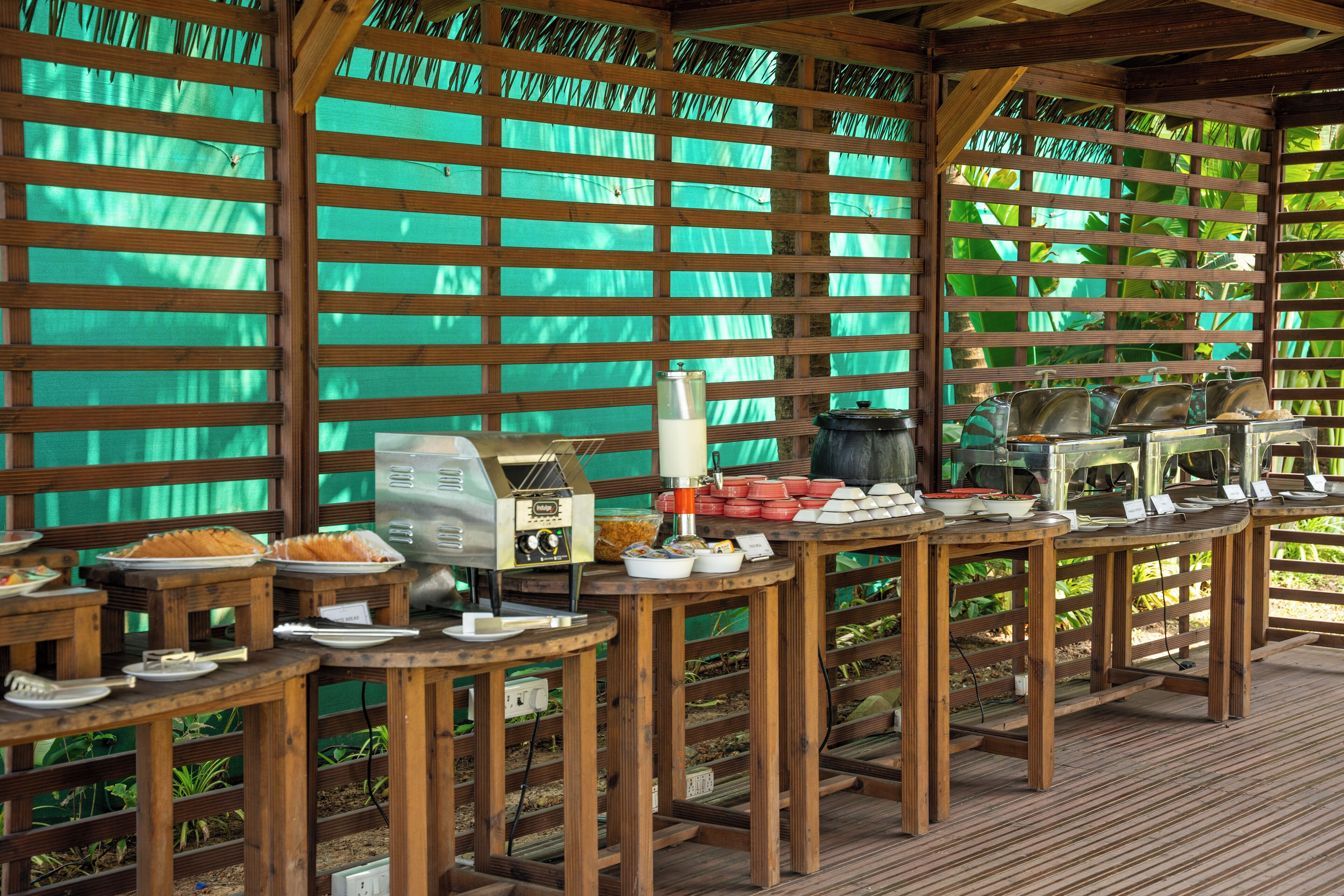 A breakfast buffet setup with multiple food stations and serving counters.