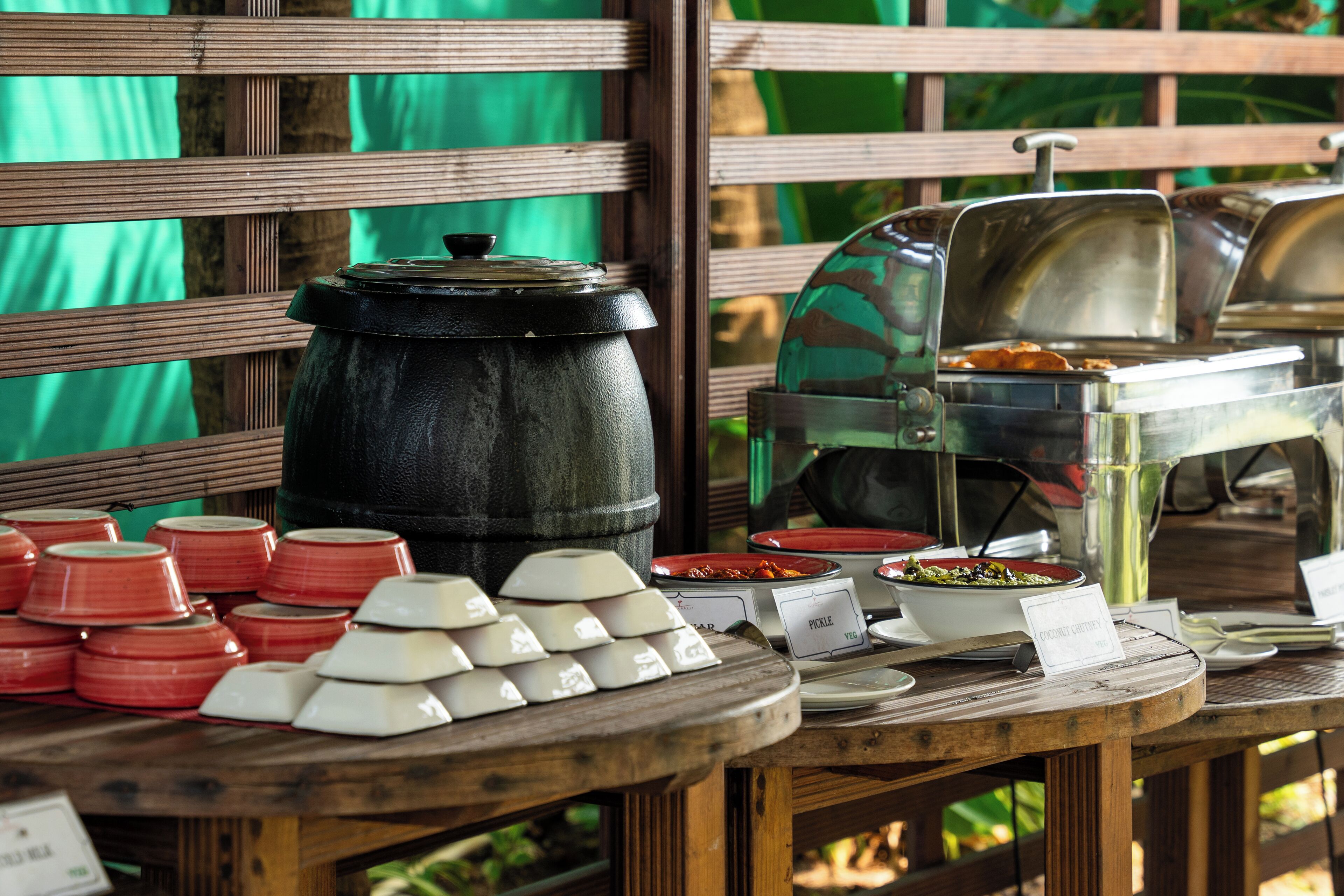 A buffet setup with various dishes and serving ware.