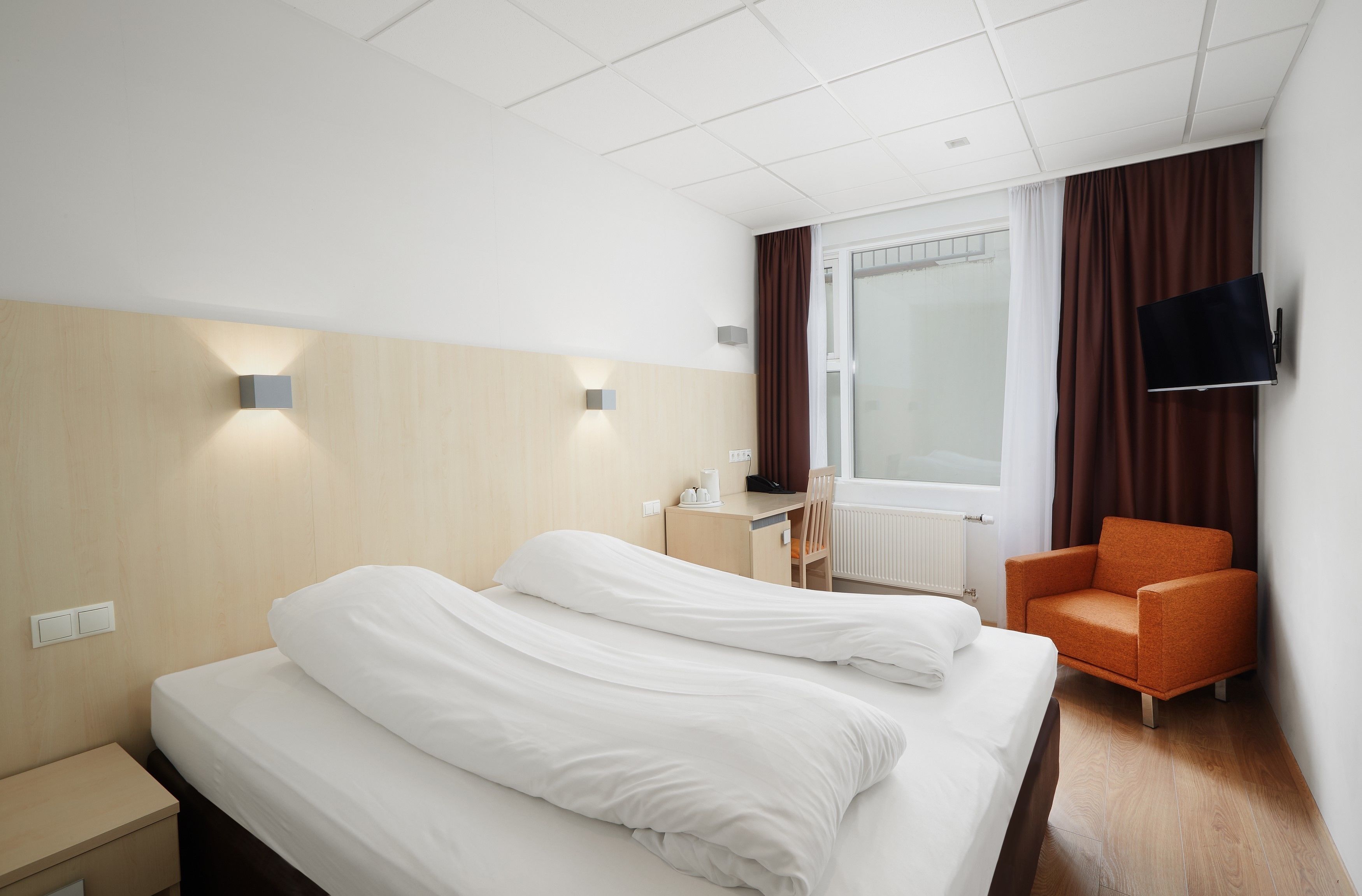 budget standard room | in-room safe, desk, blackout curtains, iron/ironing board