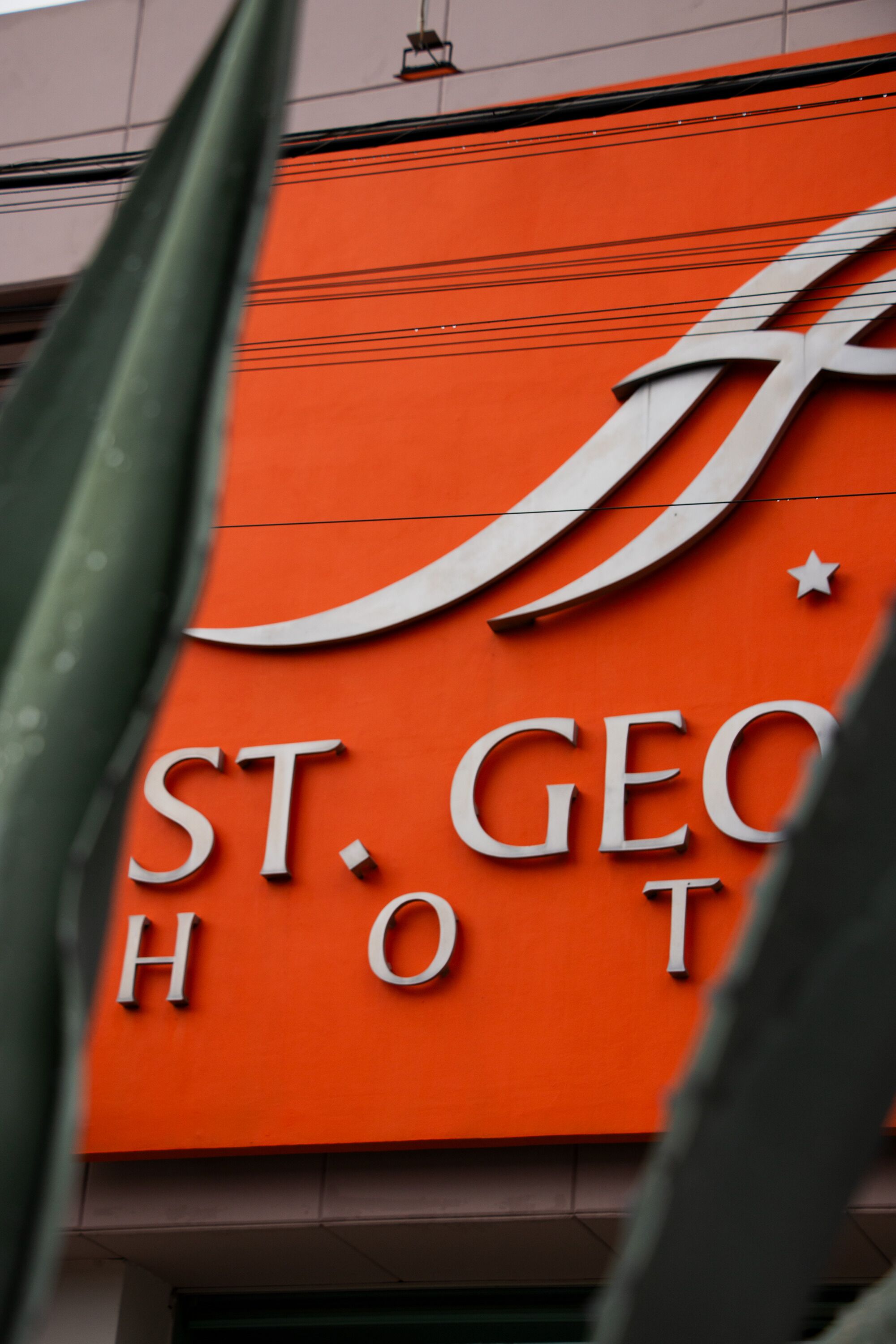 A sign for St. George's Hotel with a crescent moon and star design.