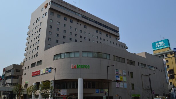 A multi-story building with a prominent 'La Merce' sign on the ground floor.