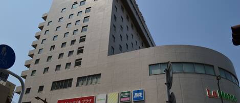 A multi-story building with a modern design, featuring a prominent curved section on the right side.