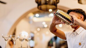 A person holding a cocktail shaker.