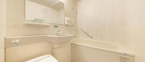 A bathroom with a toilet, sink, and bathtub.