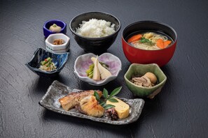 A variety of Japanese dishes including rice, soup, and meat, served on a dark surface. - Nara Washington Hotel Plaza (Nara)