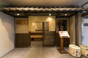 A traditional Japanese interior with tatami flooring, a shoji screen, and a signboard. - Nara Washington Hotel Plaza (Nara)