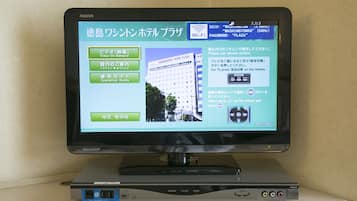 A Sharp TV on a stand with a remote control.