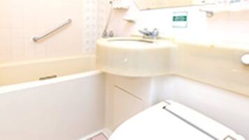 A bathroom with a bathtub, a sink, and a toilet.