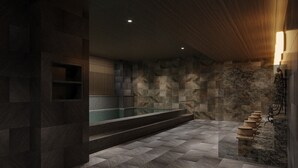 A modern bathroom with a stone wall, a glass bathtub, and wooden steps leading to a shower area. - Kumamoto Washington Hotel Plaza (Kumamoto)