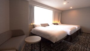 A hotel room with two beds, a small round table, and a sofa. - Kumamoto Washington Hotel Plaza (Kumamoto)