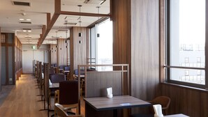 A modern restaurant with wooden paneling, long tables, and chairs. - Kumamoto Washington Hotel Plaza (Kumamoto)
