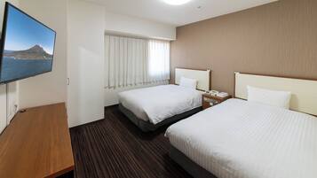 A hotel room with two beds, a TV, a desk, and a window with curtains.