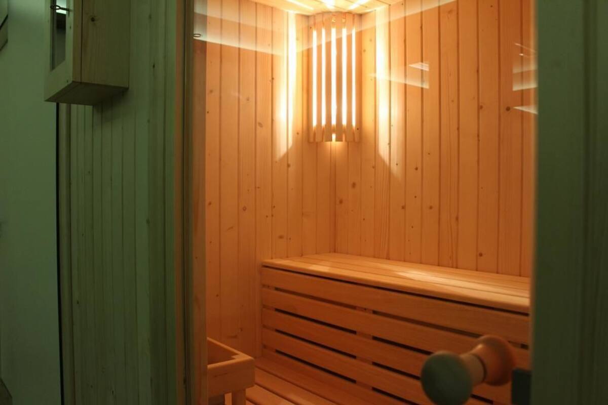 A wooden sauna with benches and a slatted floor.