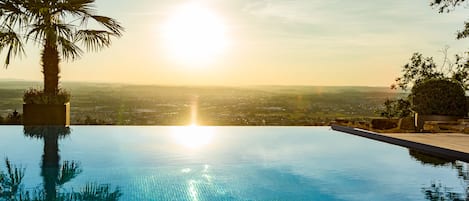 Outdoor pool, open 7:00 AM to 8:00 PM, pool umbrellas, pool loungers