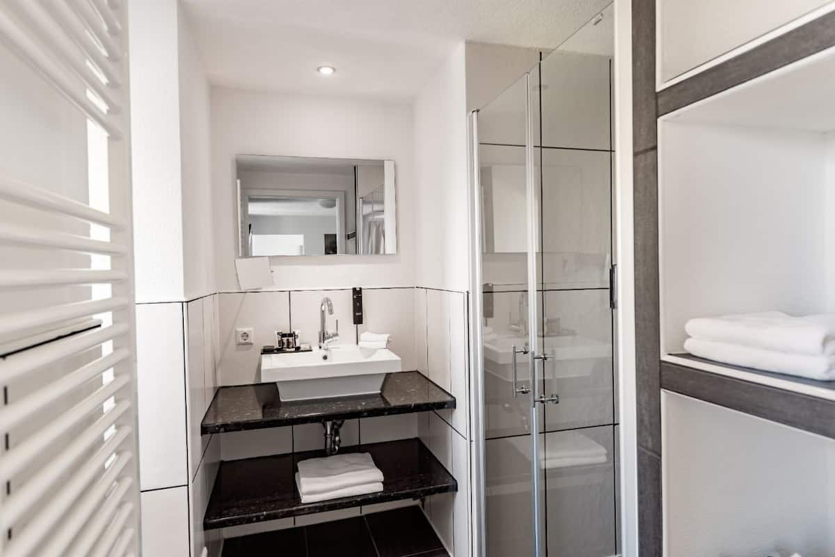 comfort apartment | bathroom | rainfall showerhead, hair dryer, bathrobes, slippers