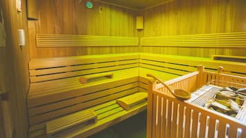 A sauna with wooden benches and a wooden bench with a towel rack.
