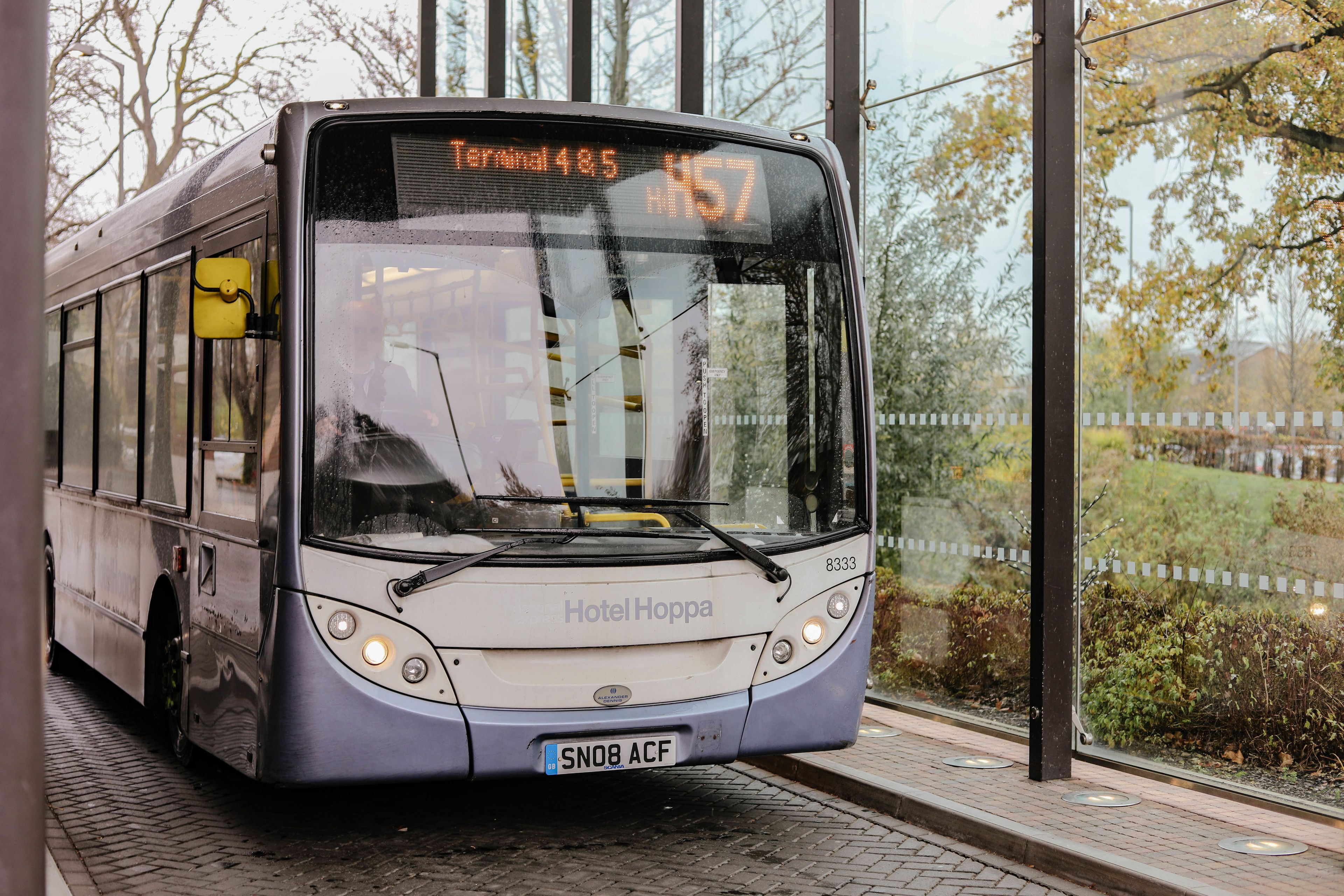 A modern bus with a digital display showing "Terminal 485" and route "H57".