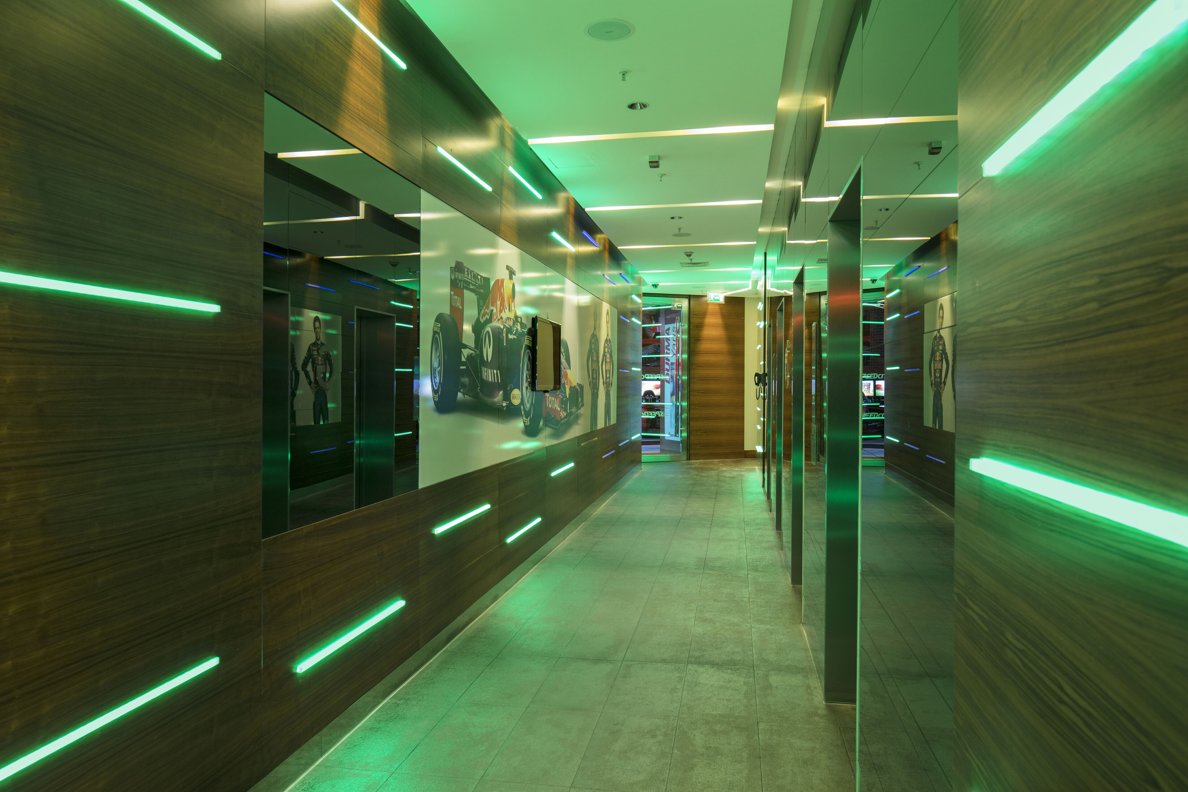 A modern hallway with wooden paneling and green neon lights.
