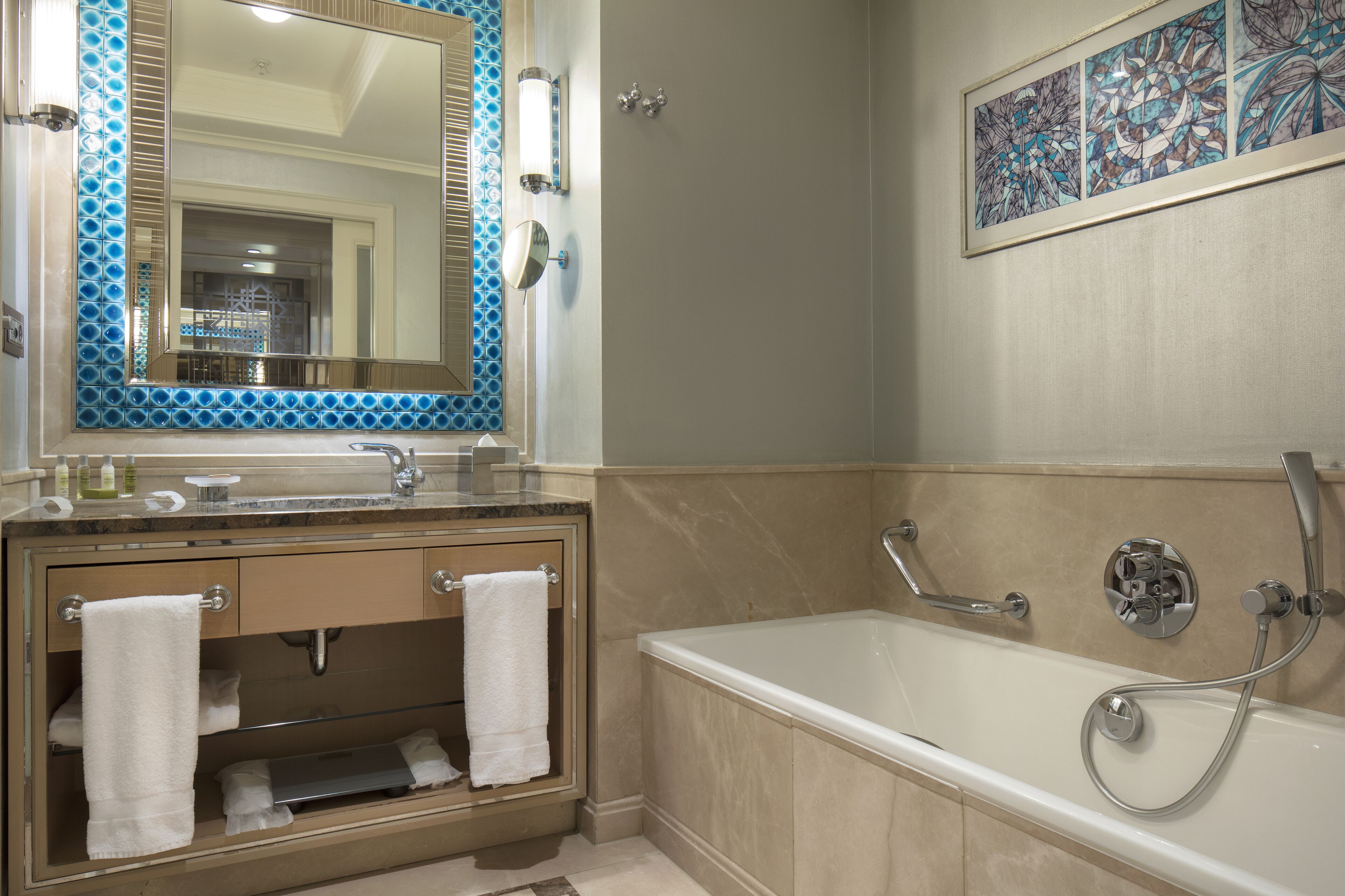 A bathroom with a bathtub, a sink, and a mirror.