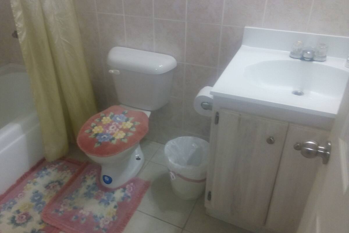 A small bathroom with a toilet, a sink, and a shower.