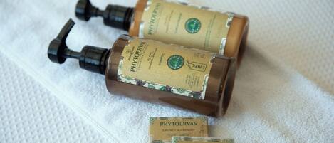 Two bottles of PHYTOERVAS shampoo and a smaller box on a white textured surface.