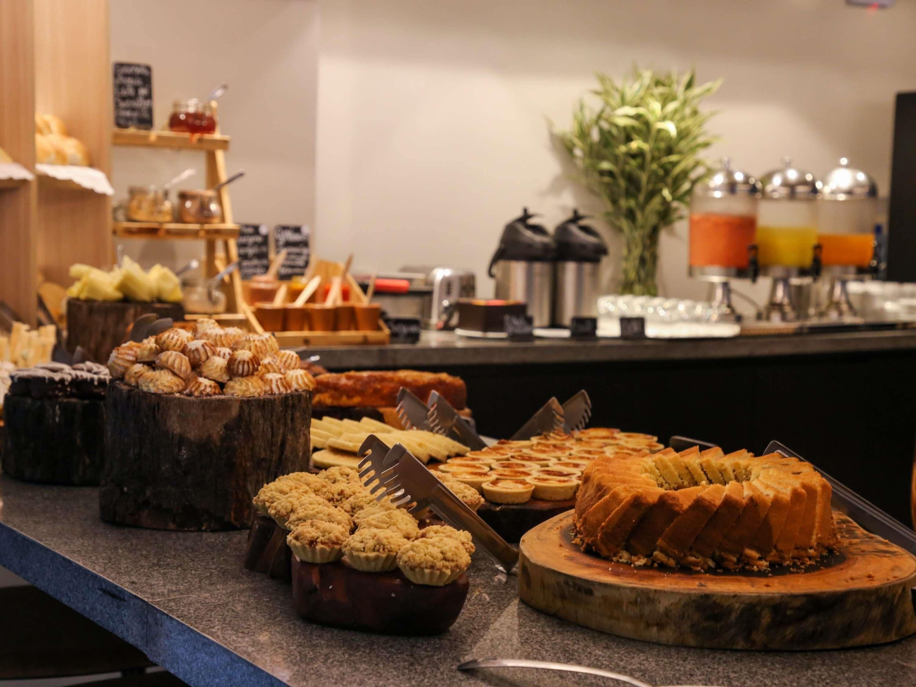 A buffet with various pastries and desserts.