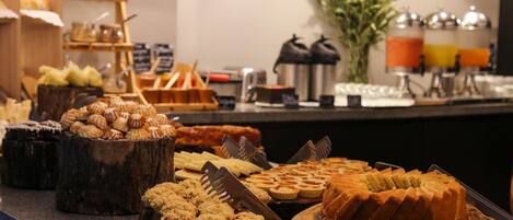 A buffet with various pastries and desserts.