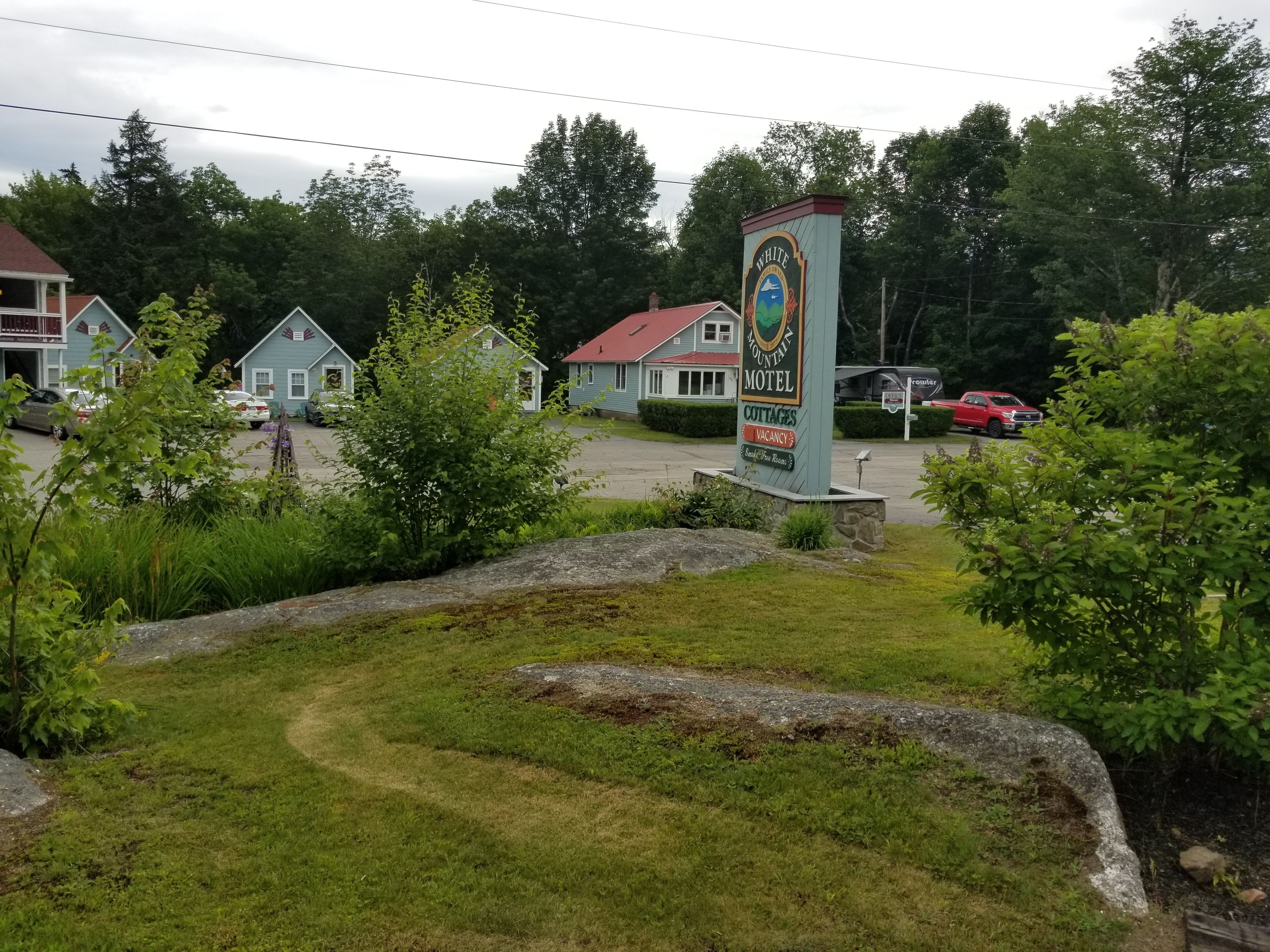A motel sign with a mountain emblem, indicating a mountain-themed establishment.
