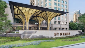 A modern building with a distinctive arched roof and the name "ST REGIS" prominently displayed. - The St. Regis Shanghai Jingan (Shanghai)