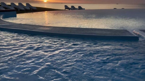 A pool with lounge chairs and a sunset view. - Diaz Hotel & Resort (Mossel Bay)