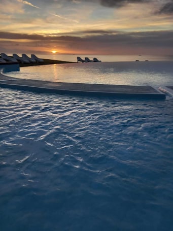 Outdoor pool, open 8:30 AM to 7 PM, pool umbrellas, sun loungers