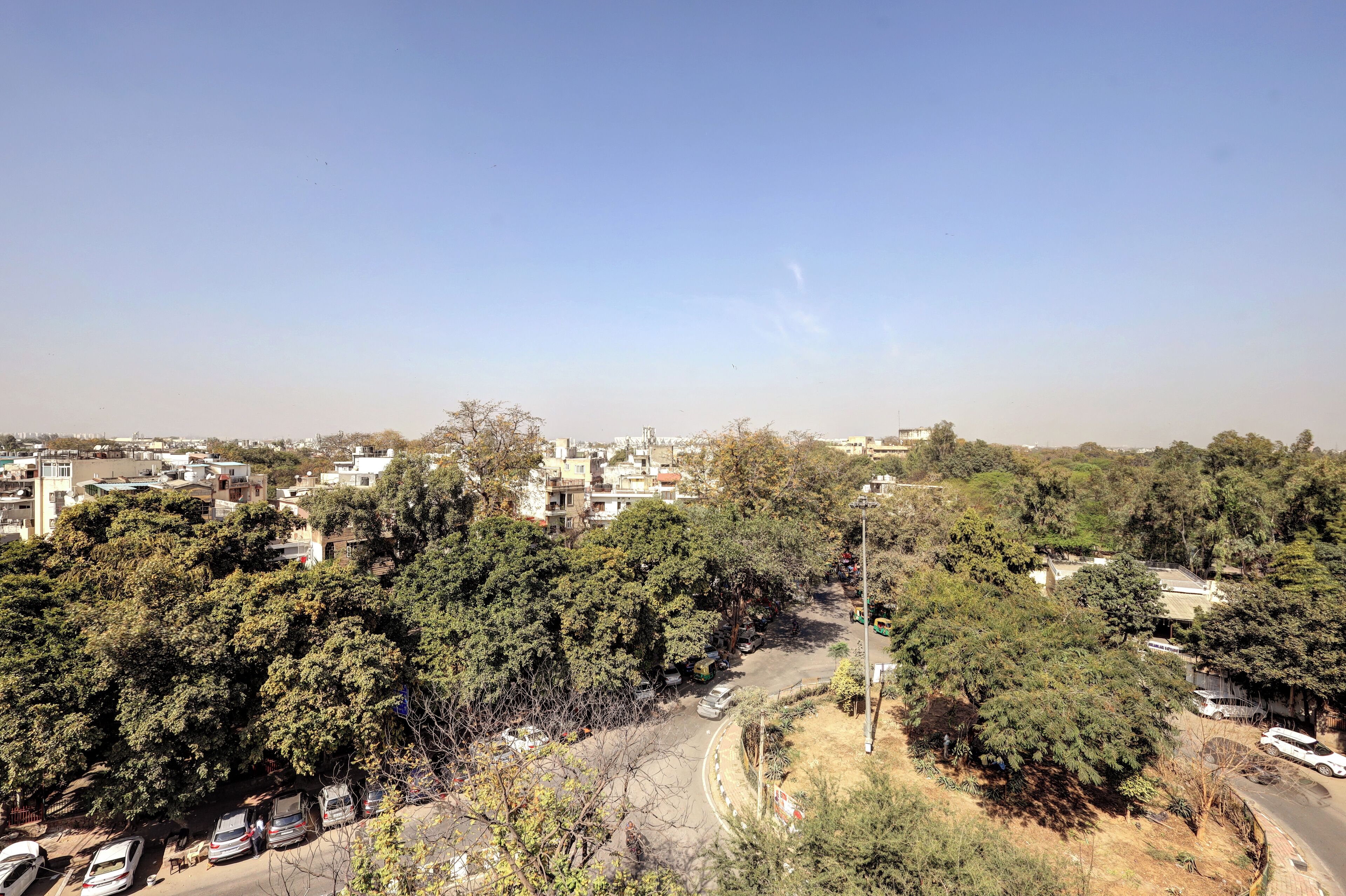 A residential area with houses, trees, and a road.