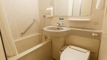 A small bathroom with a bathtub, sink, and toilet.