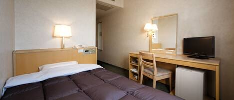 A hotel room with a bed, desk, chair, television, and a small refrigerator.