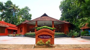 A traditional building with a tiled roof and a sign that reads "Deshadan."