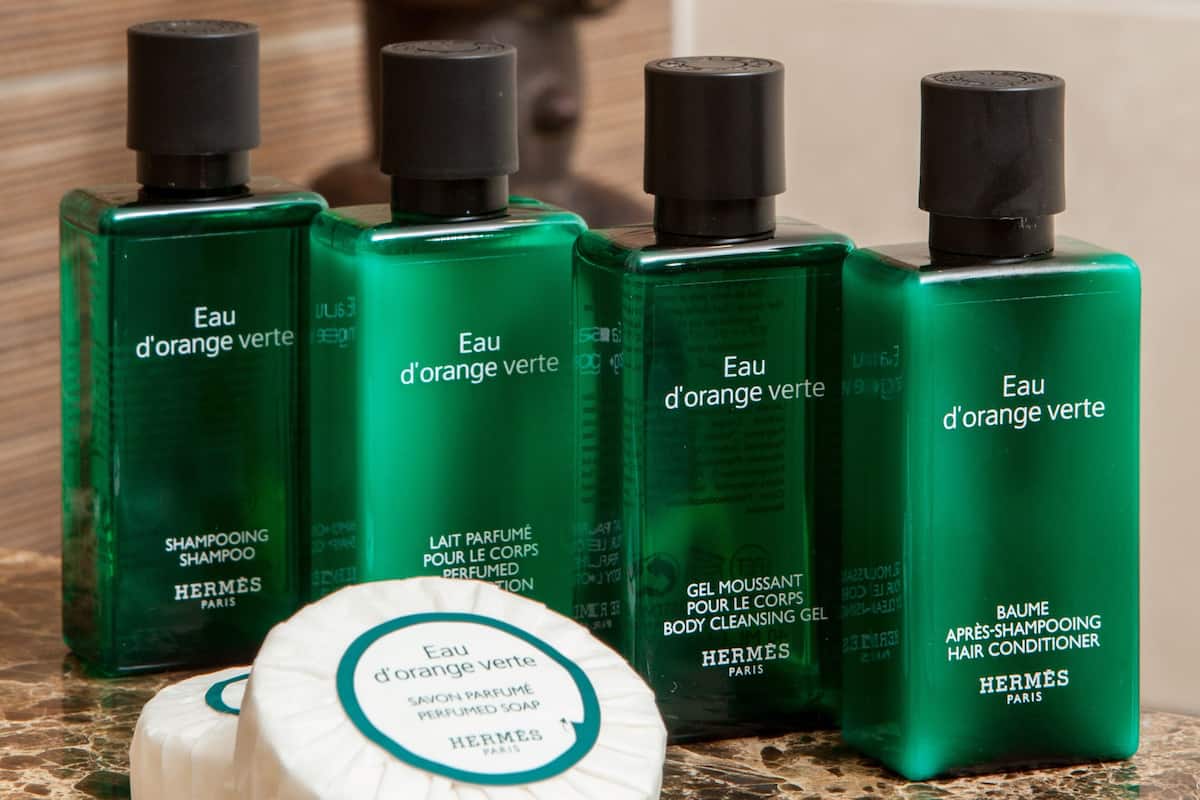 designer toiletries, hair dryer, slippers, towels