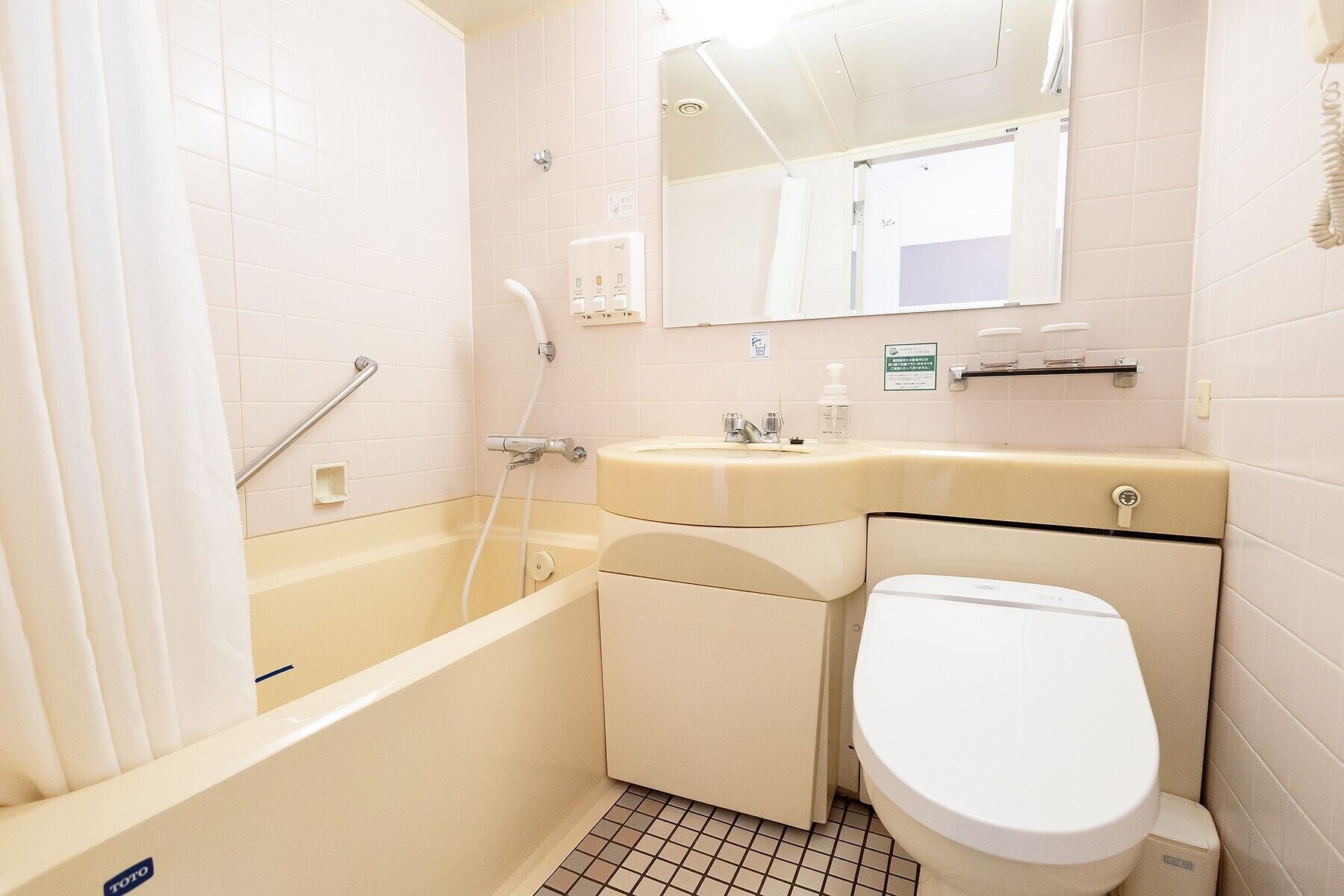 A compact bathroom with a bathtub, a toilet, and a sink.